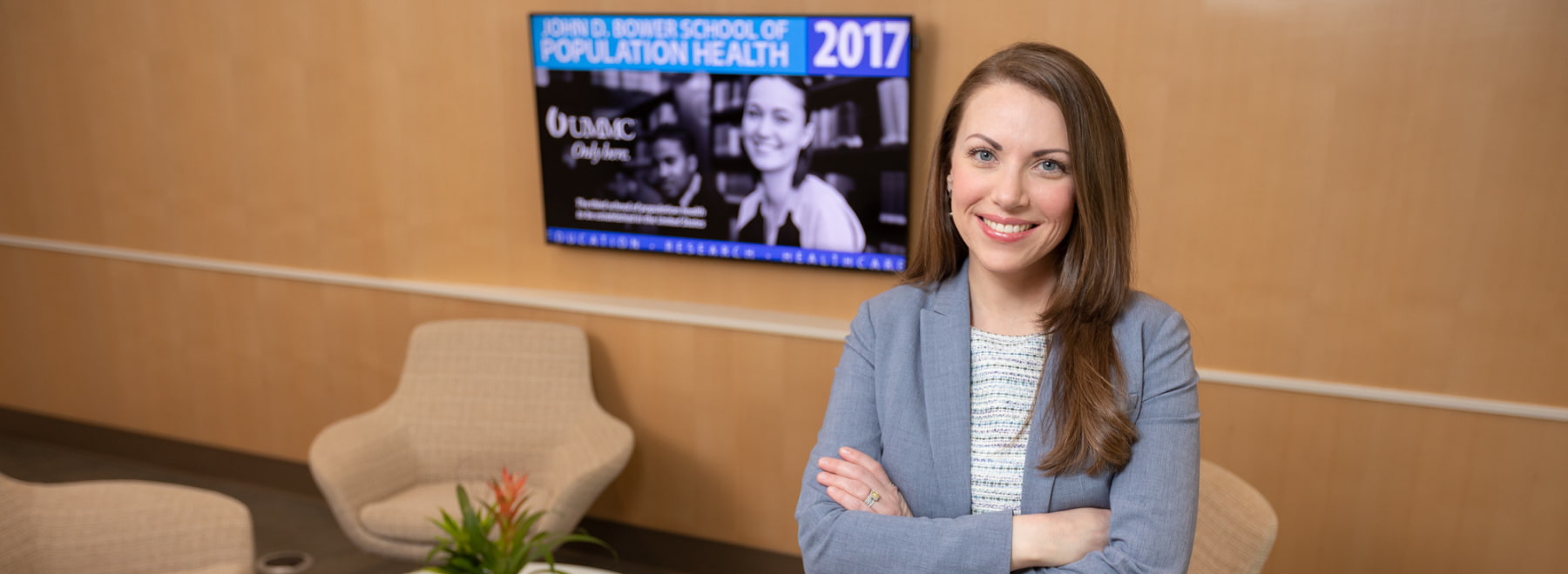 Female School of Population Health Science PhD student and Executive Director of Research at UMMC poses in her office.